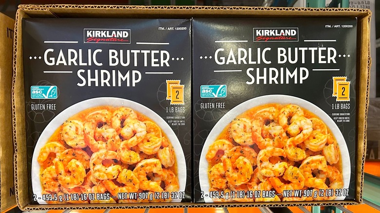 Boxes of Kirkland Signature Garlic Butter Shrimp on display at Costco