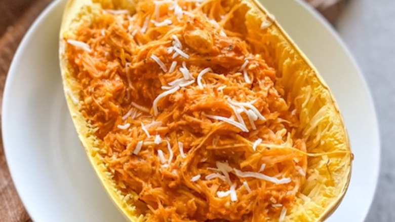 shredded chicken and cheese in spaghetti squash half