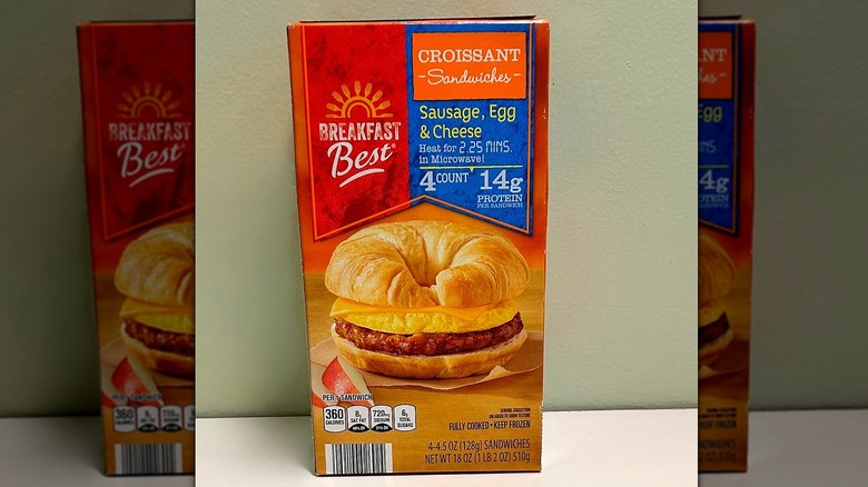 A box of Breakfast Best Croissant Sandwiches on a green and white background