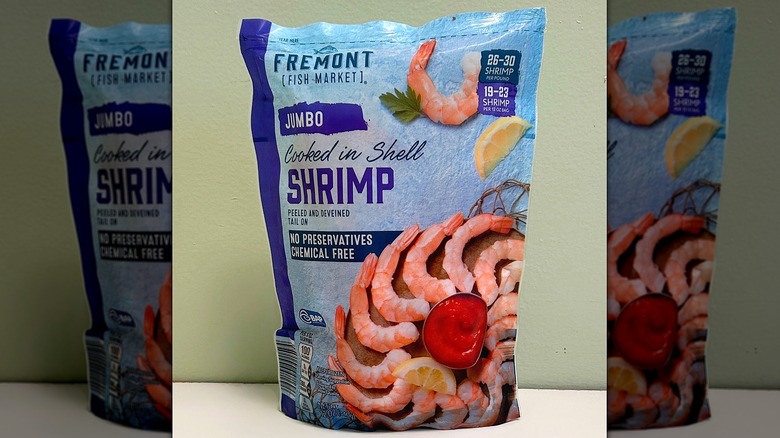 A bag of Fremont Fish Market Jumbo Shrimp on a green and white background