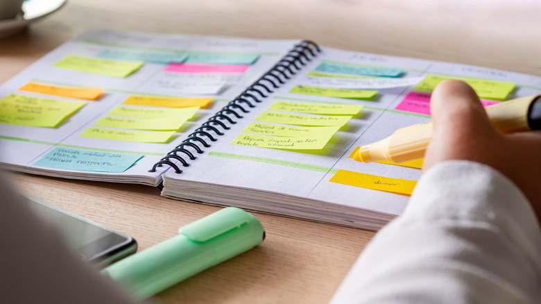 person writing in calendar