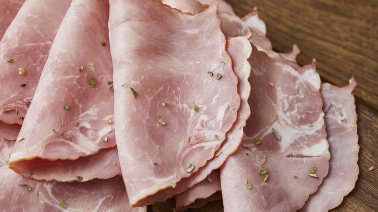 sliced ham on wooden board