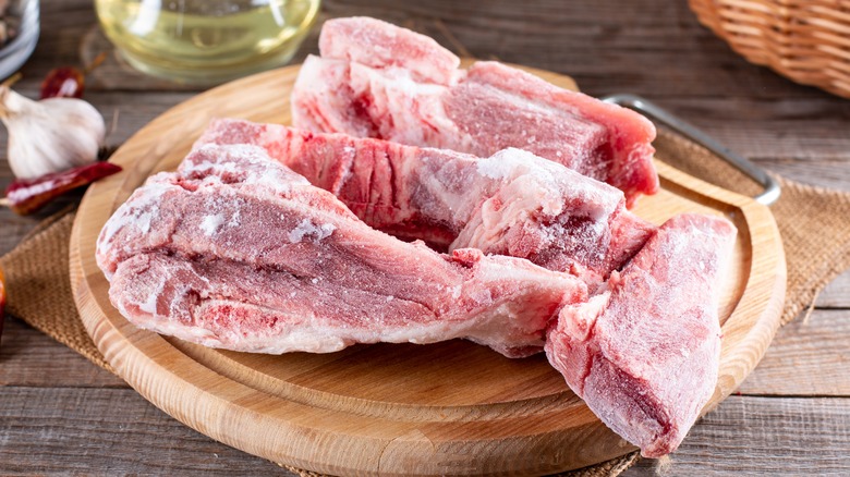 frozen pork on cutting board