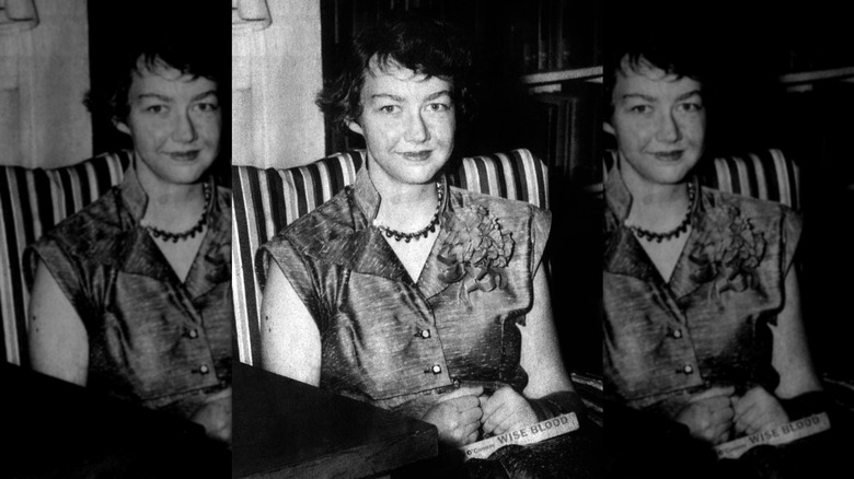 Photo of Flannery O'Connor with book in lap