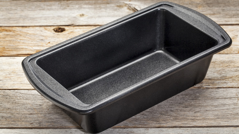 Metal loaf pan on wood