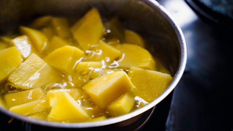 boiling pot of potatoes on stove