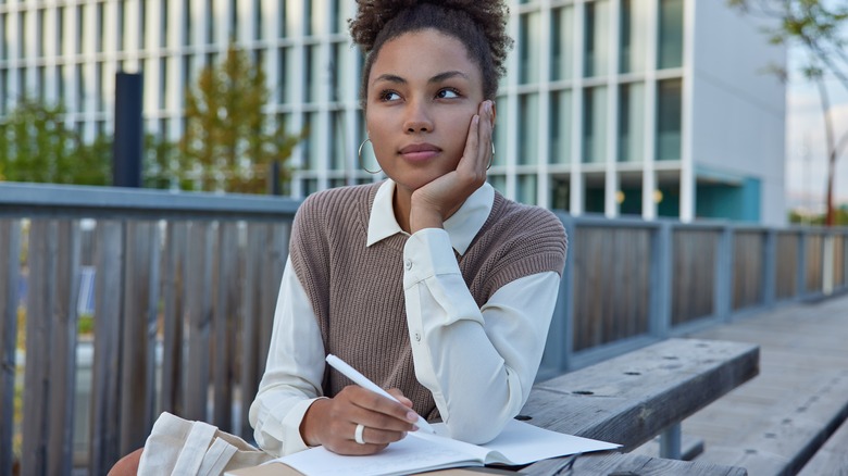 woman thinking before she writes