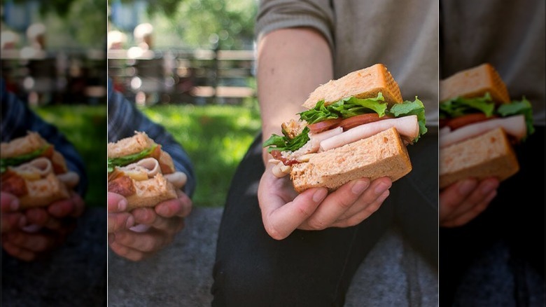 hand holding turkey sandwich