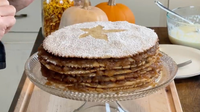 Appalachian apple stack cake garnished with powdered sugar on a cake tray
