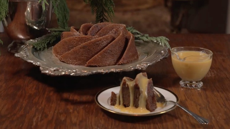 Whole and sliced woodford pudding on white plate