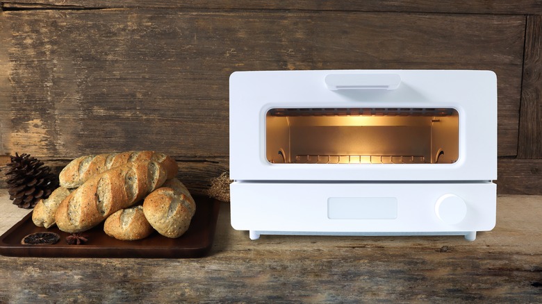 Loaves of bread next to white toaster oven