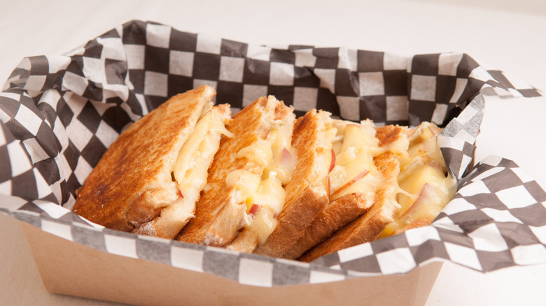 Brie and apple grilled cheese in take out container