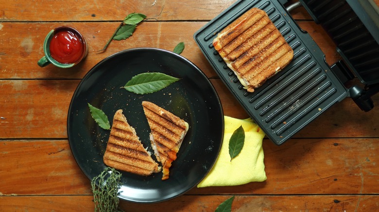 Grilled cheese sandwich on a black plate made on a panini press