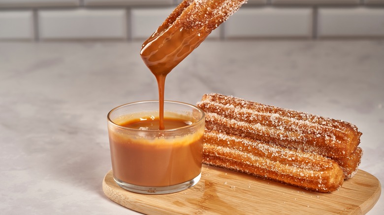 Churros dipped in brown glaze