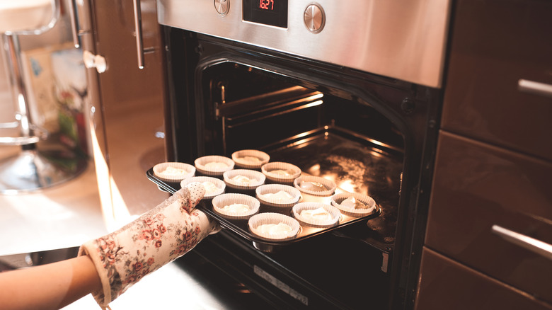 putting cupcakes in oven