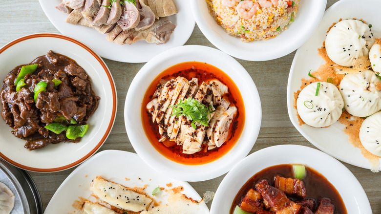 Tabletop with a variety of different Chinese dishes on display