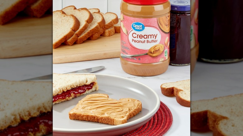 Walmart Great value creamy peanut butter jar with a plate and a peanut butter jelly sandwich