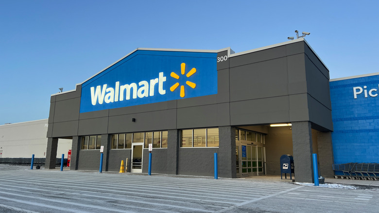 The entrance and parking lot of a Walmart store in America