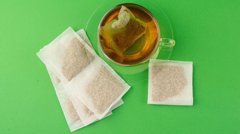 Bags and cup of green tea