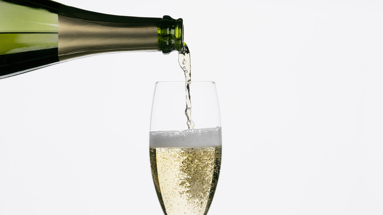 Sparkling wine being poured into a champagne flute
