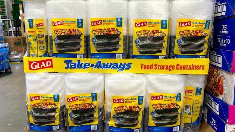 Several packages of Glad Take-Aways Containers with Lids stacked on cardboard boxes