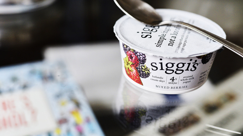 container of yogurt with spoon