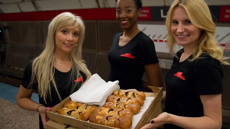 Pizza Hut workers holding P'Zolos