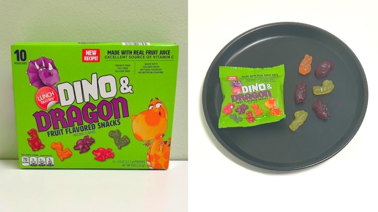 A box of Lunch Buddies Dino and Dragon Fruit Flavored Snacks next to a black plate with gummy snacks