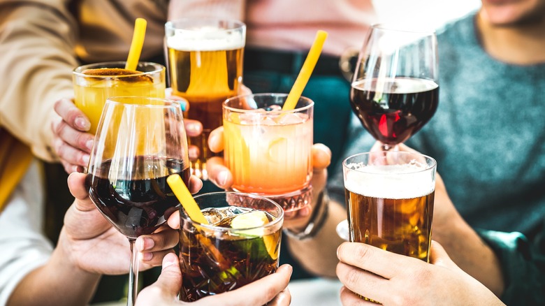 people clinking cocktails together