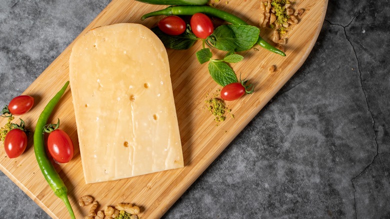 Chunk of gouda on cutting board