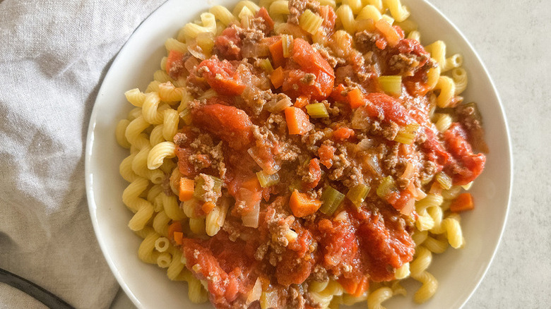 Simple Bolognese Sauce over noodles in white bowl