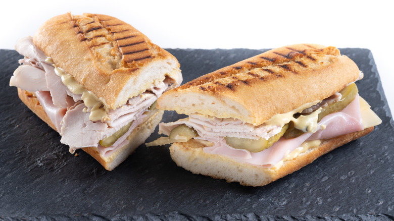 Traditional Cuban sandwich on a black surface