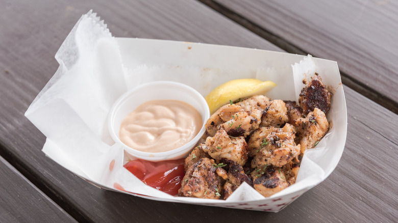 Gator tail bites with a lemon wedge and dipping sauce