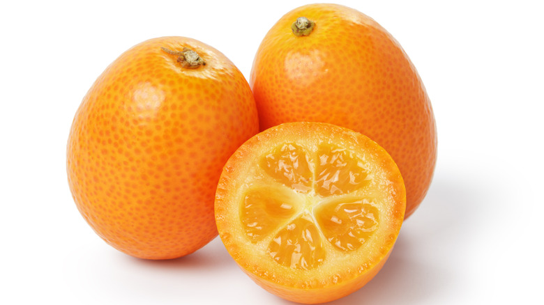 Ripe kumquats isolated against a white background