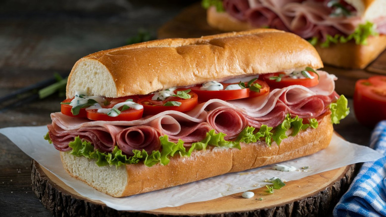 Italian Sub on a white paper against a wooden background
