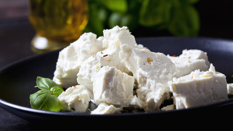 Chunks of feta cheese on a black plate
