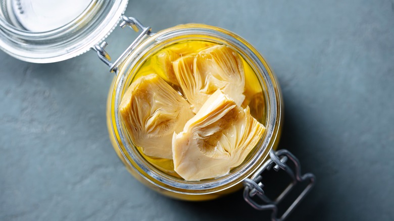 Glass jar of marinated artichoke hearts