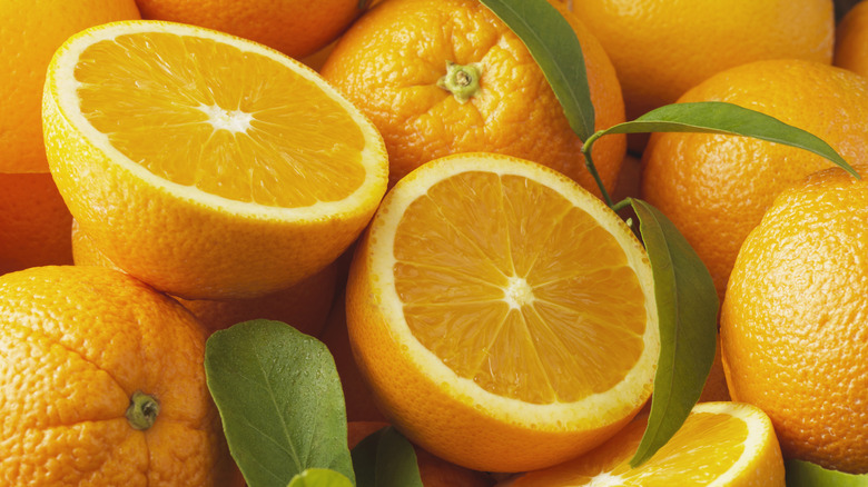 Pile of whole and halved oranges