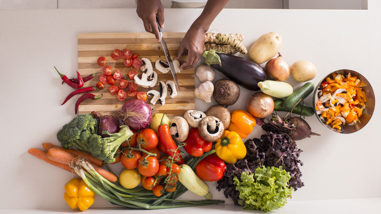 woman chopping veggies for salad