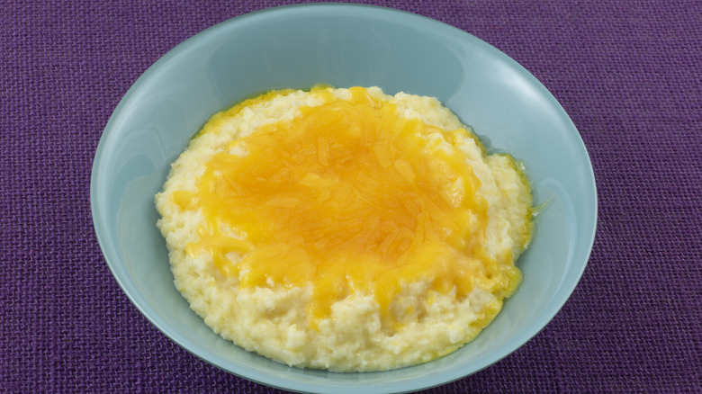 Grits covered with cheese in a blue bowl