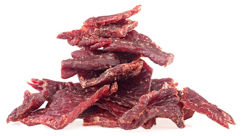 A pile of red-brown beef jerky