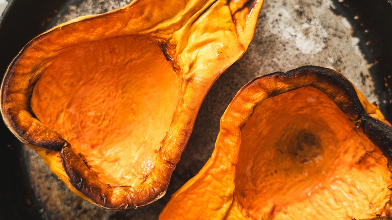 A freshly butternut squash, sliced in two and freshly roasted, slightly charred at the edges