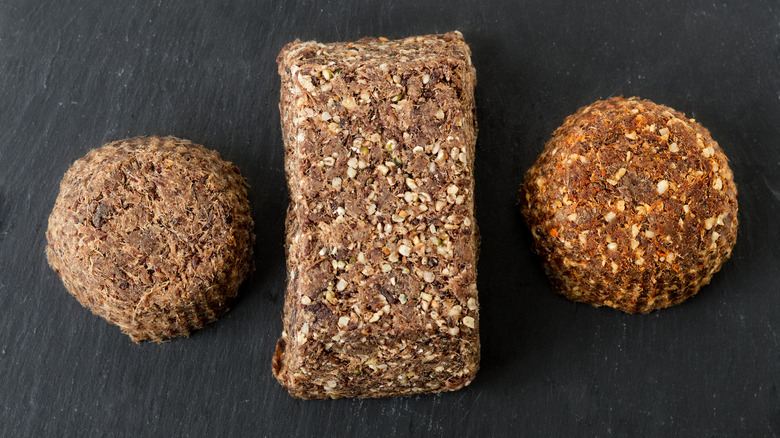 Three types of Pemmican lined up on a black surface