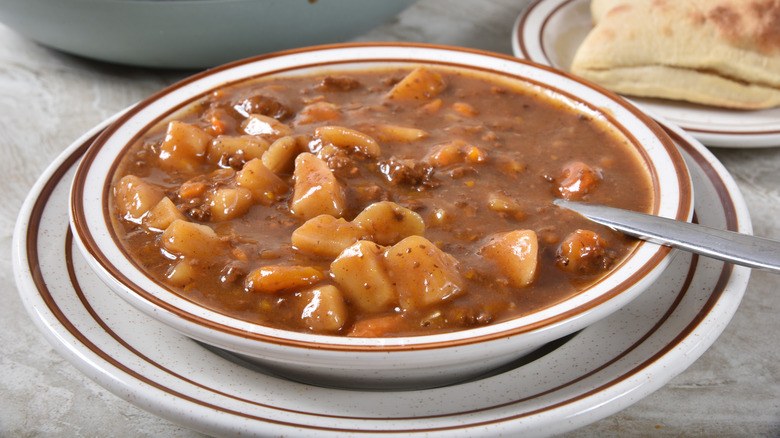 Beef stew, a modern alternative to buffalo stew, in a white bowl