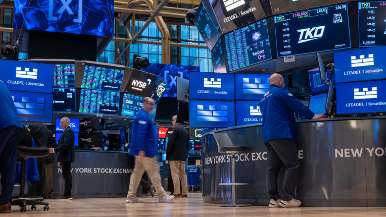 Stock exchange floor with people and screens