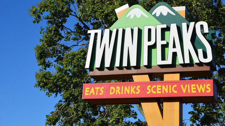 Sign for Twin Peaks restaurant with trees in the background