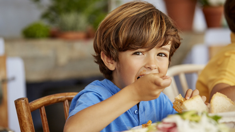 Happy child eating at table