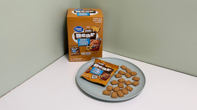 A box of Great Value Mini Bear Honey Graham Cookies next to a plate with bear cookies