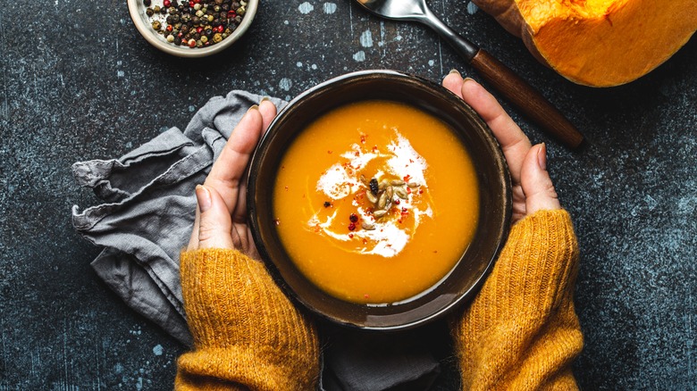 Woman holding a soup bowl