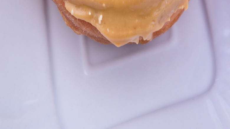 Peanut butter frosted donut with jelly